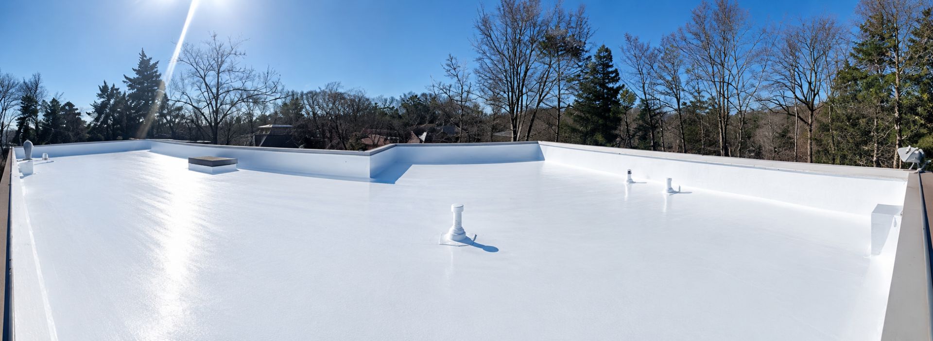 Crew working on a flat commercial roof in Atlanta